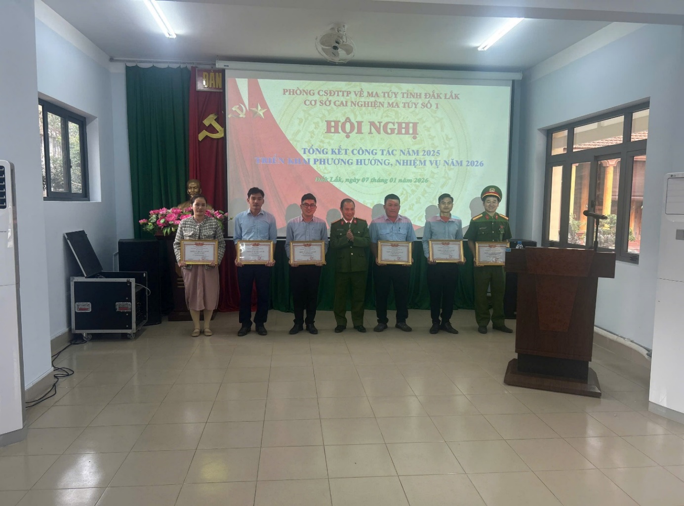 '''A group of people holding certificates
 Description automatically generated'''