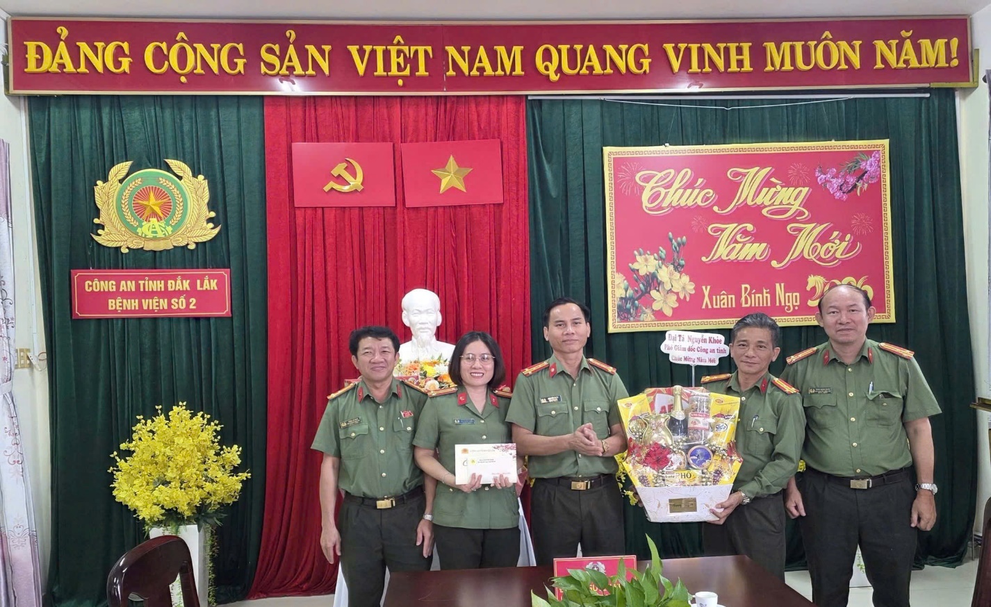 ''A group of people standing in front of a red and green curtain
AI-generated content may be incorrect.''