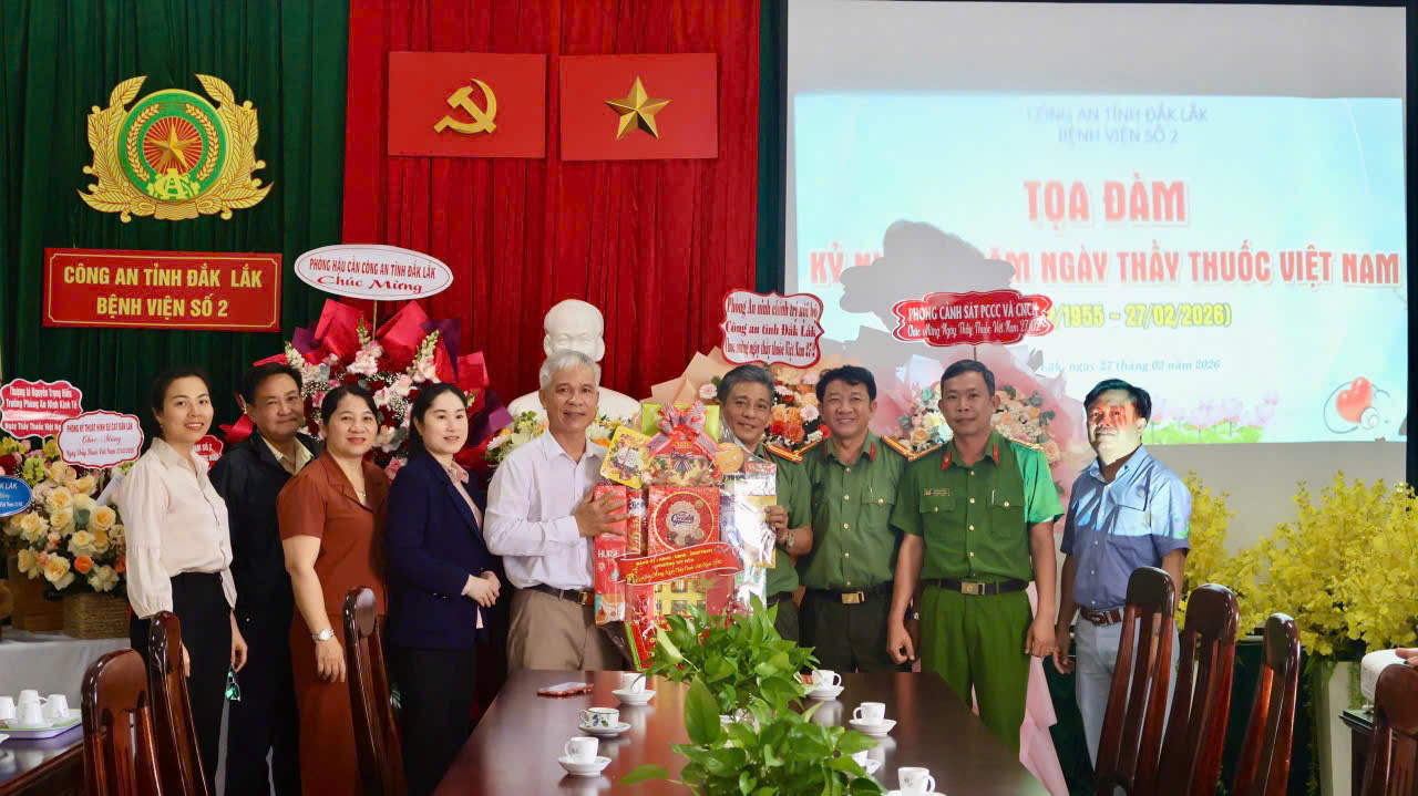 ''A group of people standing in front of a table

AI-generated content may be incorrect.''