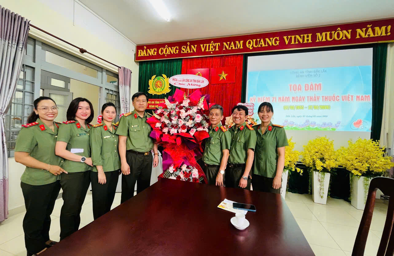 ''A group of people standing in front of a table

AI-generated content may be incorrect.''