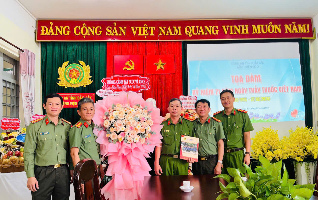 ''A group of men in uniform standing in front of a table with flowers

AI-generated content may be incorrect.''
