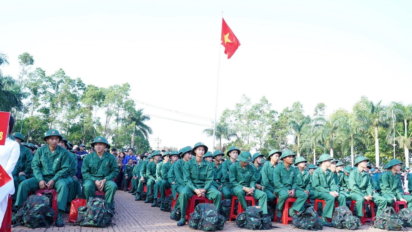 'A group of people in green uniforms sitting on red chairs

AI-generated content may be incorrect.'