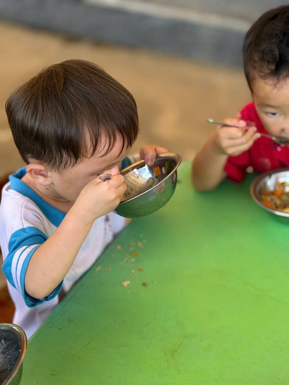 'A child eating from a bowl
AI-generated content may be incorrect.'