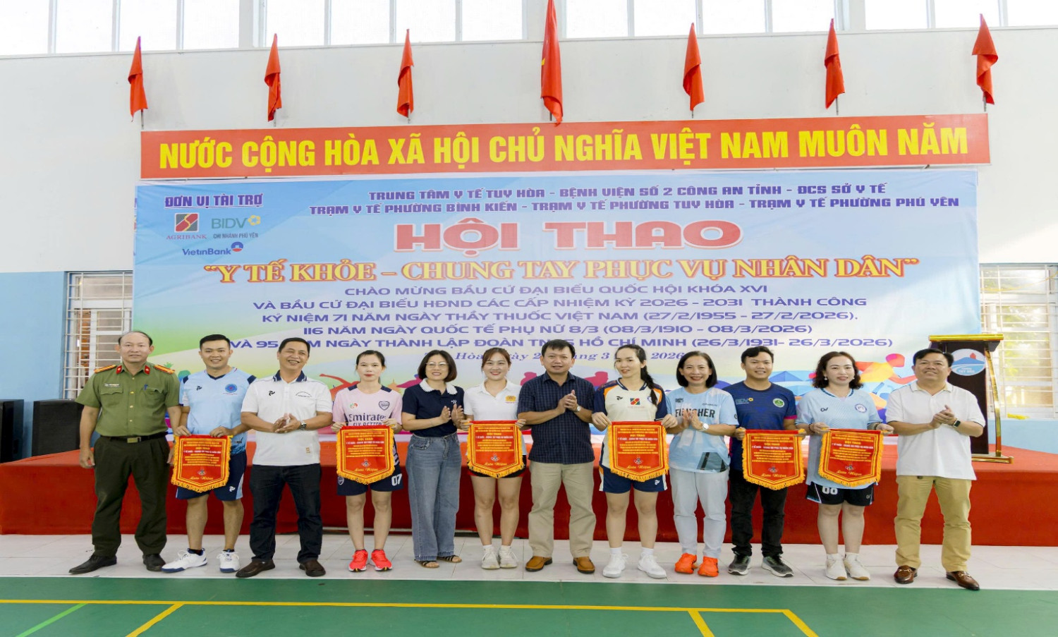 '''A group of people standing in front of a banner

AI-generated content may be incorrect.'''