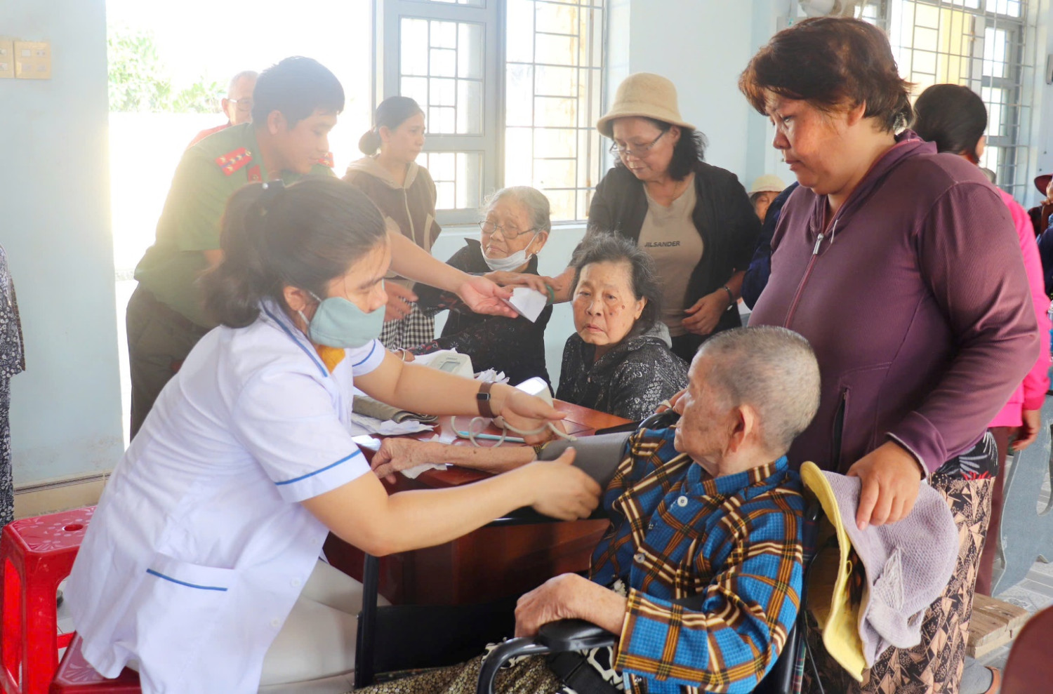 'A nurse giving a blood shot to a group of people

AI-generated content may be incorrect.'