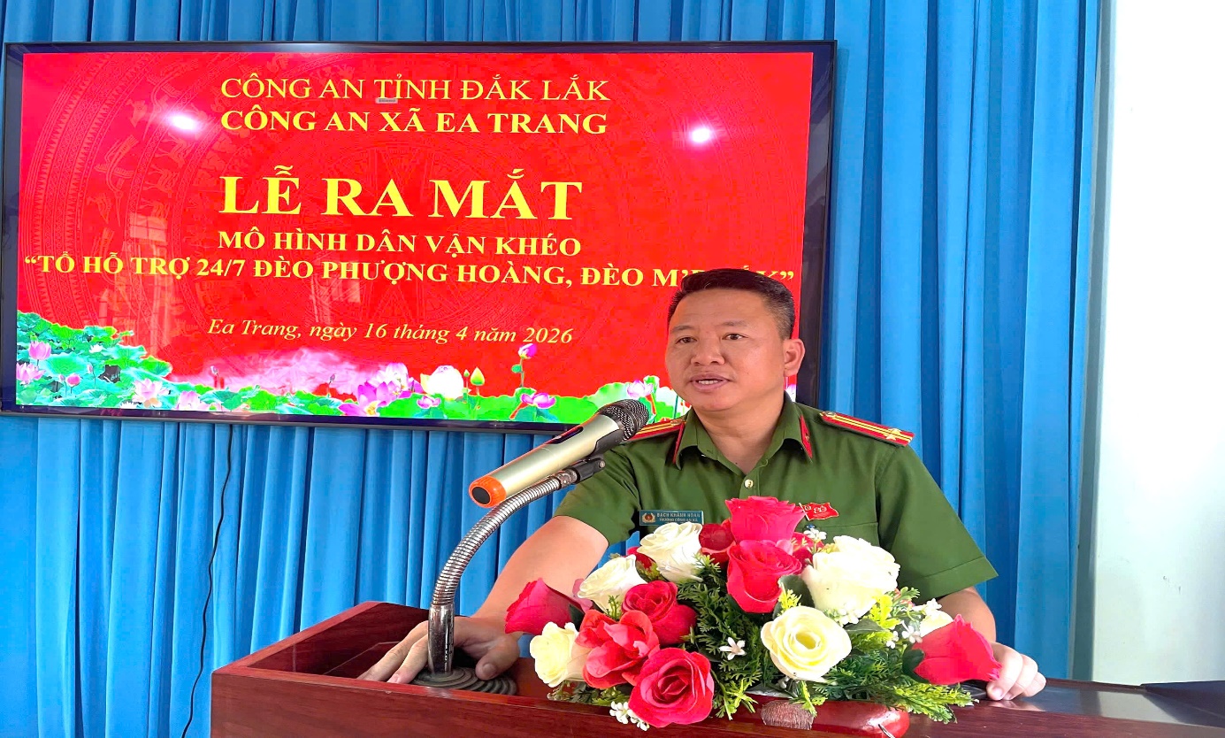 'A person in uniform standing at a podium with a microphone and flowers

AI-generated content may be incorrect.'