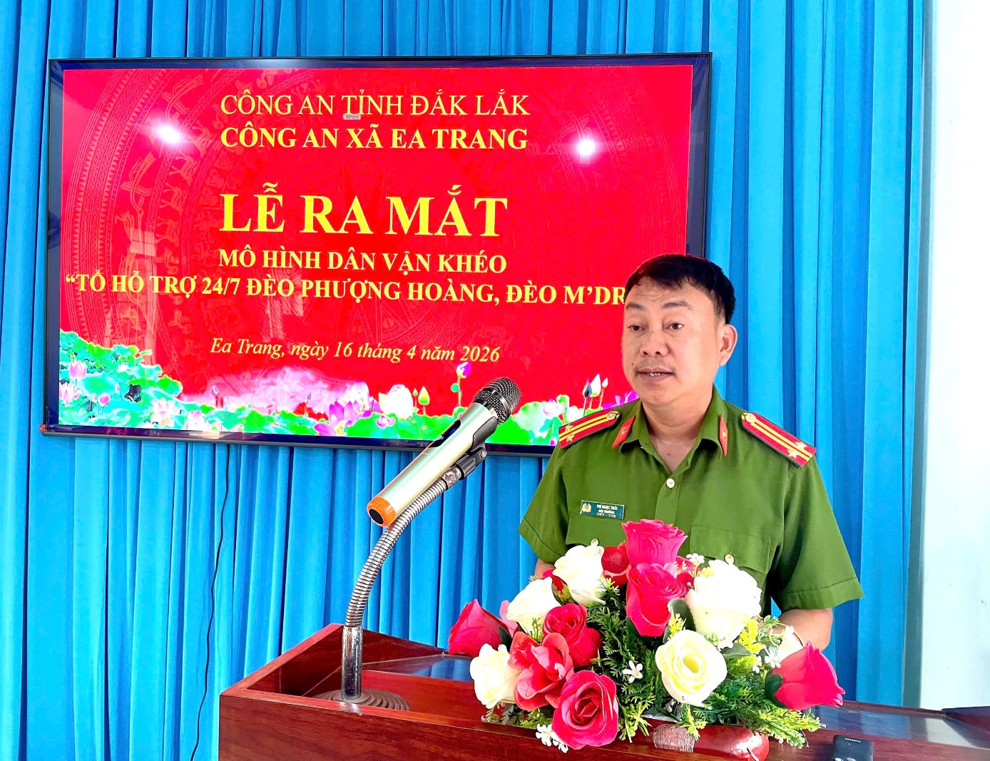 'A person in uniform standing at a podium with flowers

AI-generated content may be incorrect.'