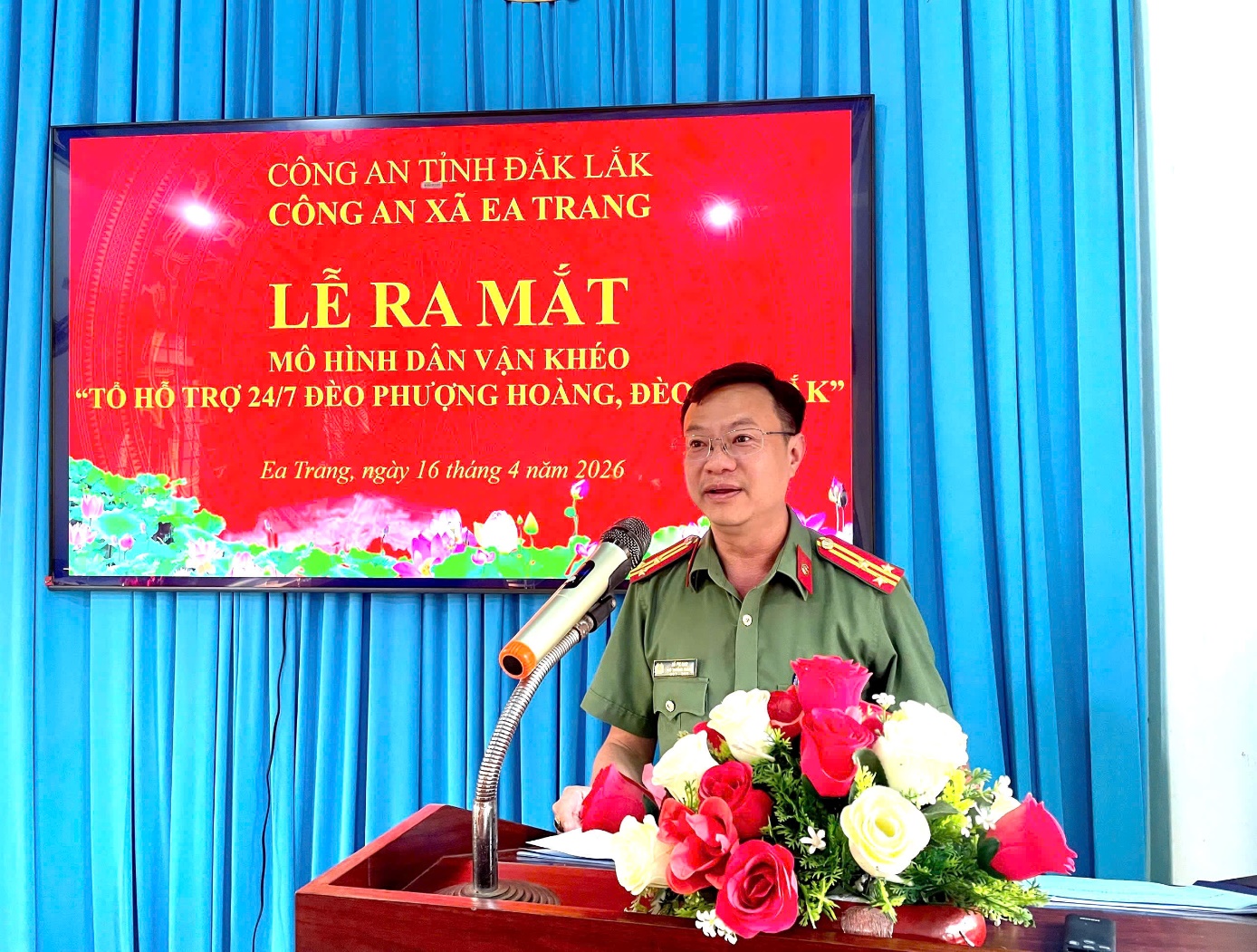 'A person in uniform standing at a podium with a microphone and flowers

AI-generated content may be incorrect.'